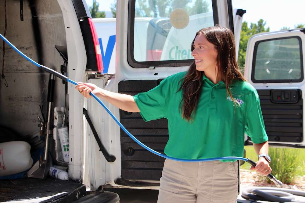 chem-dry technician getting carpet cleaning equipment from cleaning van in west jordan