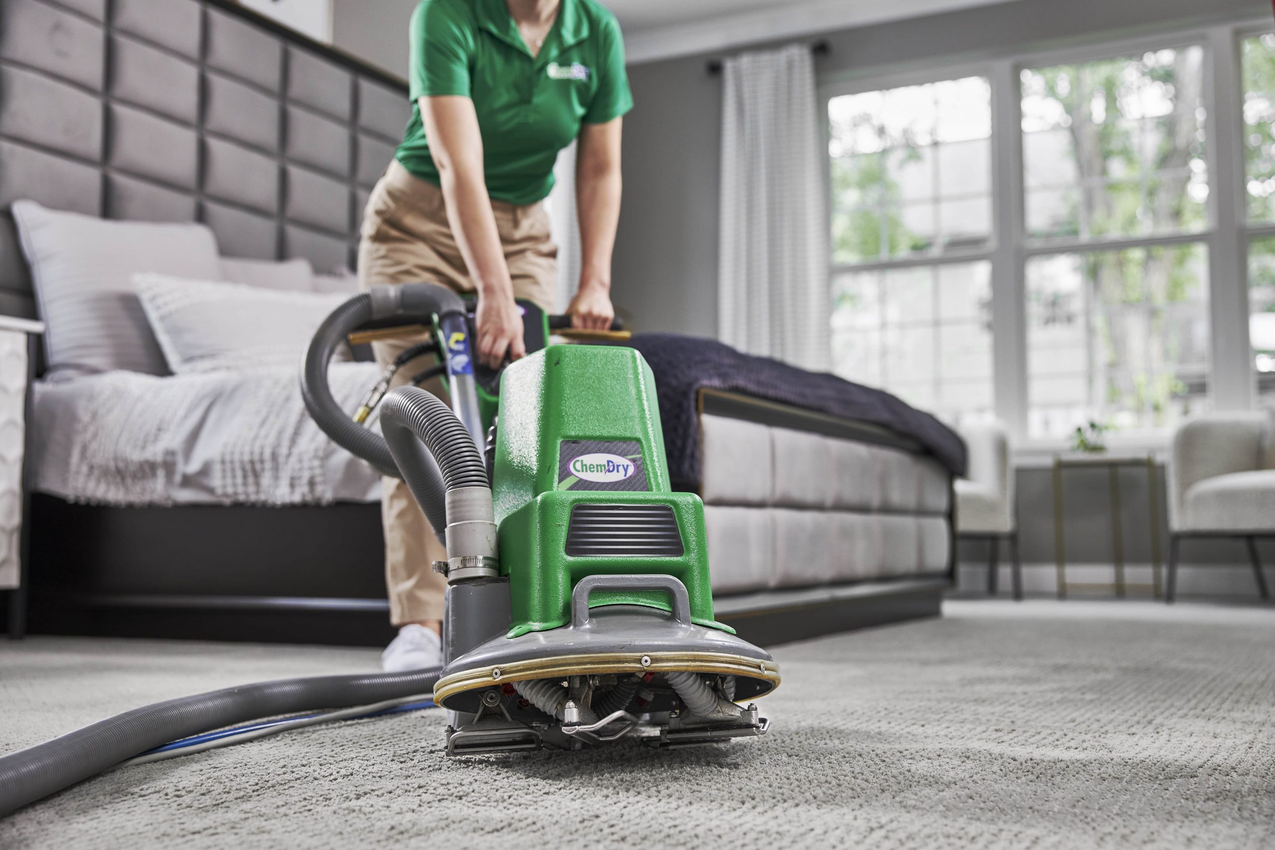 tech performing carpet cleaning 