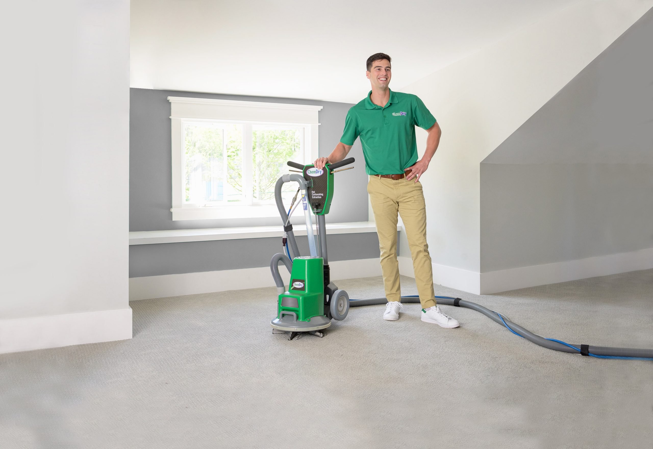 carpet cleaning technician using a powerhead cleaning equipment