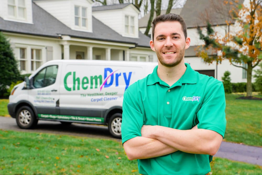 chem-dry technician standing with carpet cleaning van